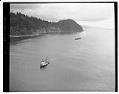 Image of Aerial view of Washington State coast, with a tugboat pulling logs, 1959
