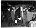 Image of Men being loaded into a police paddy wagon, Seattle, 1936