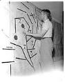 Image of Man with civil defense map of Seattle, 1958