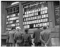 Image of Public employment office exterior showing men looking at listings, Seattle, 1936