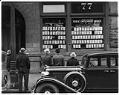 Image of Men looking at listings posted in the window of the Public Employment Office, Seattle, 1936