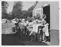 Image of Young women farm volunteers waiting for the shower, June 28, 1943
