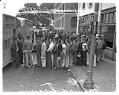 Image of Young men board buses for the Victory Youth Farm Aid Corps, 1942