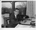 Image of Mineo Katagiri seated at a desk, possibly in Seattle, 1966