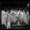Image of Roosevelt High School football team getting trophy after beating Garfield, Seattle, 1964