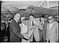 Image of Elvis Presley presenting a gift to Washington Governor Albert Rosellini, Monorail Station, Westlake Avenue, Seattle, September 5, 1962