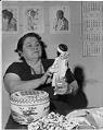 Image of Pearl Warren examining Native American art, Seattle, 1962