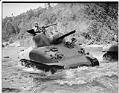 Image of Man test driving Sherman tank in river, Renton, 1942