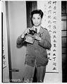 Image of Chinese man with camera, Seattle, 1935