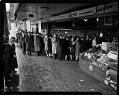 Image of Shoppers lined up in front of E&E Meat Market on Olive Way for meat during wartime rationing, 1943