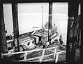 Image of Roy Olmstead in a boat arriving at a dock, Steilacoom, 1931