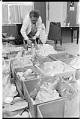 Image of Margaret Jensen, coordinator at South Park food bank, with boxes of food, Seattle, February 4, 1975