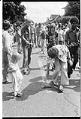 Image of Central Area residents painting a red line down the middle of Roy Street to protest red-lining bank policies, August 17, 1975