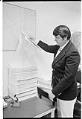 Image of King County Det. Capt. Nick Mackie with computer printouts related to 