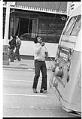 Image of Curtis Robinson checking the power poles of his Metro trolley bus, Seattle, November 1975