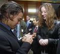 Image of Apolo Ohno signing autograph for a fan at P-I Sports Star banquet, Seattle, January 27, 2003