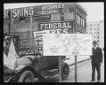 Image of Jitney bus driver with sign criticizing streetcar system, Seattle, 1918