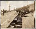 Image of Construction workers on plank road during Alki Avenue regrade, April 19, 1913