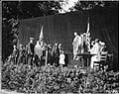 Image of Man in ancient Greek dress and other performers onstage during the 