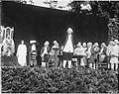 Image of Man in colonial dress and others performing in the 