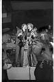 Image of Paul McCartney and George Harrison singing during the Beatles concert, Seattle Center Coliseum, August 21, 1964