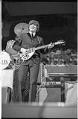 Image of John Lennon on guitar at the Beatles concert, Seattle Center Coliseum, August 21, 1964