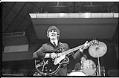Image of George Harrison playing guitar at the Beatles concert, Seattle Center Coliseum, August 21, 1964
