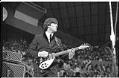 Image of John Lennon performing at the Beatles concert, Seattle Center Coliseum, August 21, 1964