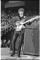 Image of George Harrison performing at the Beatles concert, Seattle Center Coliseum, August 21, 1964