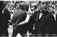 Image of Men carrying an overcome fan at the Beatles concert at Seattle Center Coliseum, August 21, 1964