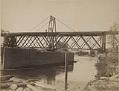 Image of Two men standing on Seattle, Lake Shore & Eastern railway drawbridge across Snohomish River, circa 1890
