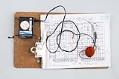 Image of Bill Nye’s baseball scoring clipboard and radio, 1980s-1990s