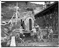 Image of Men emptying cement into form at dam construction site, circa 1937