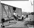 Image of Men loading boxcar at pier, circa 1935