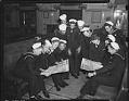 Image of Sailors looking at V-E Day newspaper, May 1945