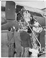 Image of War brides and children disembarking from plane, probably in Seattle, 1950