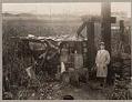 Image of Mayor Robert Harlan standing by a shack at Hooverville, October 27, 1931