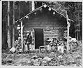 Image of David Denny at log cabin near Lake Keechelus, 1899