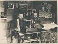 Image of Two miners weighing gold in cabin, near Nome, Alaska, circa 1900
