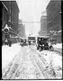 Image of Cars and streetcar stuck in snow on Pike Street, Seattle, 1916