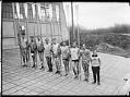 Image of University of Washington varsity crew team in front of shellhouse, Seattle, 1924