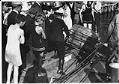 Image of Policeman pulling trunk with murder victim's body out of Lake Union, Seattle, August 8, 1921