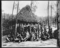 Image of Igorot men and children with Masonic Lodge Members in front of Igorot hut, Alaska-Yukon-Pacific Exposition, Seattle, 1909