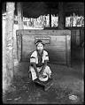 Image of Young woman making clay pot in Igorrote Village, Alaska-Yukon-Pacific Exposition, Seattle, 1909