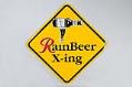 Image of Mock road crossing sign advertising Rainier Beer, ca. 1996