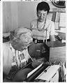 Image of Ida Daly in her office with Hazel Flagler Begeman, Seattle, August 1973