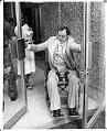 Image of Wheelchair user Mike Kovell using swinging doors, Seattle, July 1978