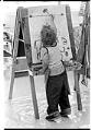 Image of Terrez Weir painting at El Centro de la Raza's bilingual child care program, Seattle, September 1974