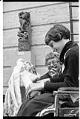 Image of Docent Evelyn Klebanoff showing Indian mask to child in wheelchair, May 24, 1977