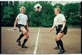 Image of Maj Surowiecki and Bernadette Noonan kicking a soccer ball, May 1994